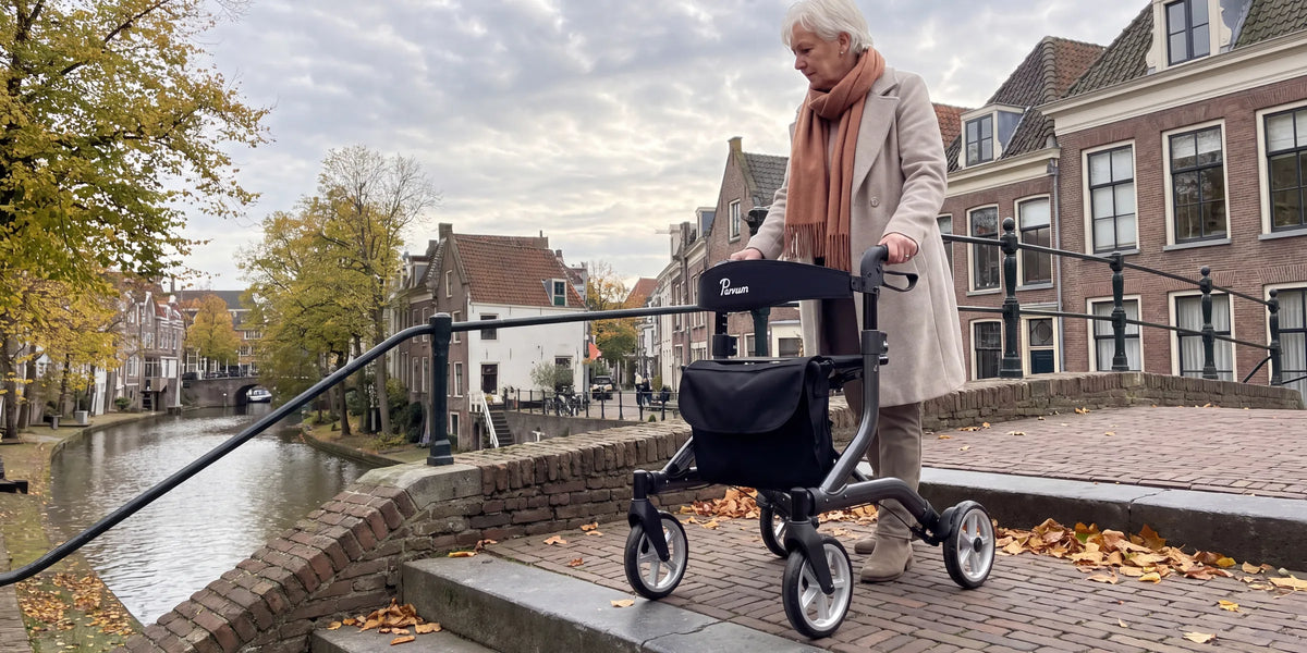 Parvum SuperLight in anthracite on a stone bridge over a canal; a woman with white hair stops for a moment.